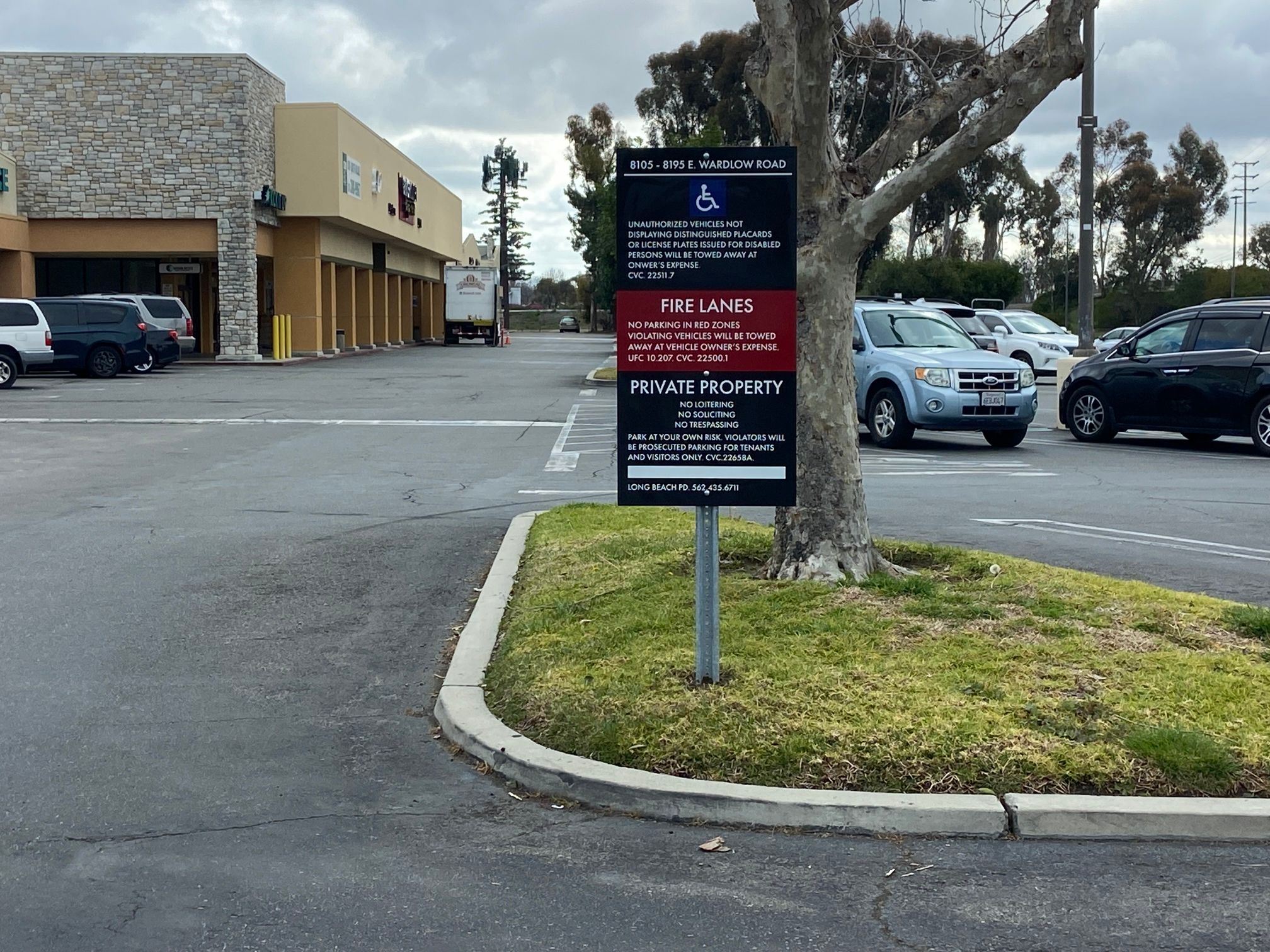 Post mounted property management signs at a Long Beach shopping center