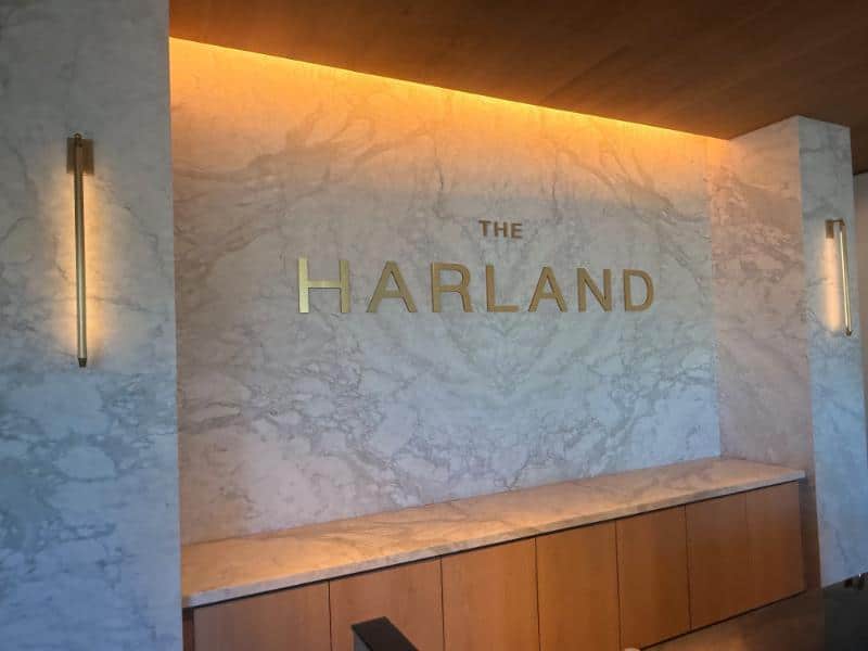 3D brushed metal lobby logo sign at The Harland apartments