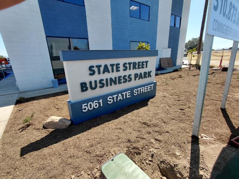 Laser-cut acrylic letters on standoffs for a business park monument sign